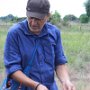 Paul takes a soil sample.
